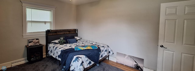 bedroom featuring a baseboard radiator and dark wood-type flooring