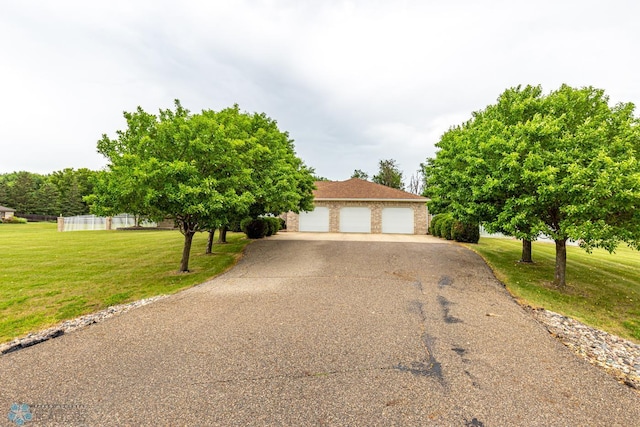 view of front facade featuring a garage and a front lawn