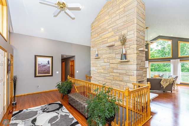 living room with hardwood / wood-style flooring, high vaulted ceiling, and ceiling fan