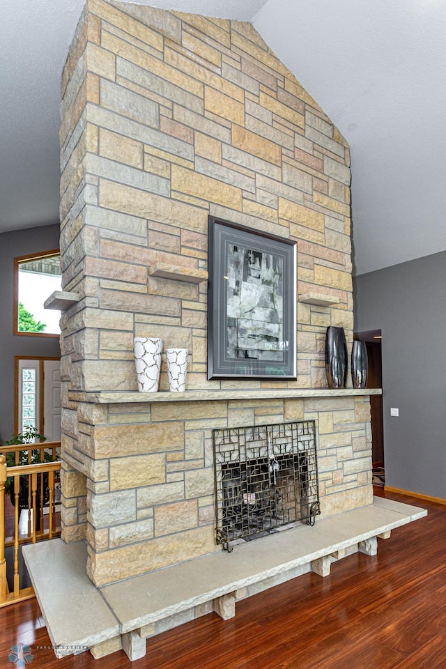 details featuring a stone fireplace and hardwood / wood-style flooring