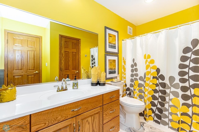 bathroom featuring toilet and vanity