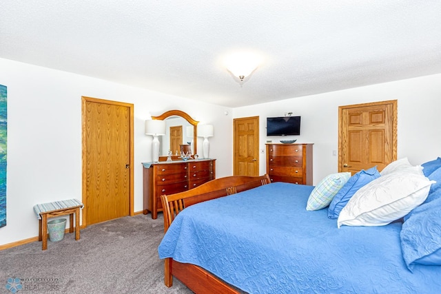 bedroom with carpet and a textured ceiling