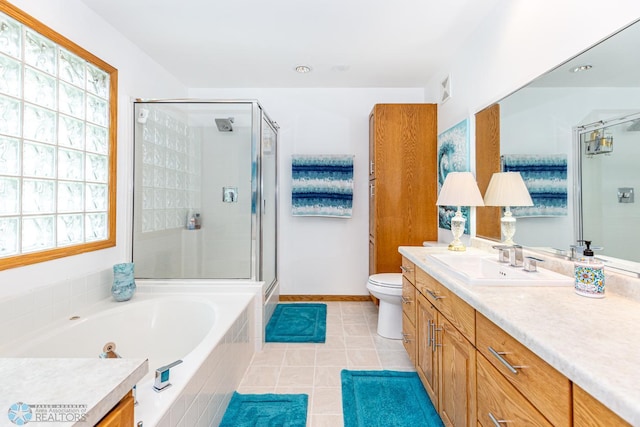 full bathroom featuring tile patterned flooring, toilet, vanity, and plenty of natural light