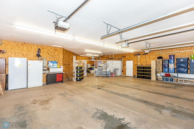 garage with white refrigerator and a garage door opener