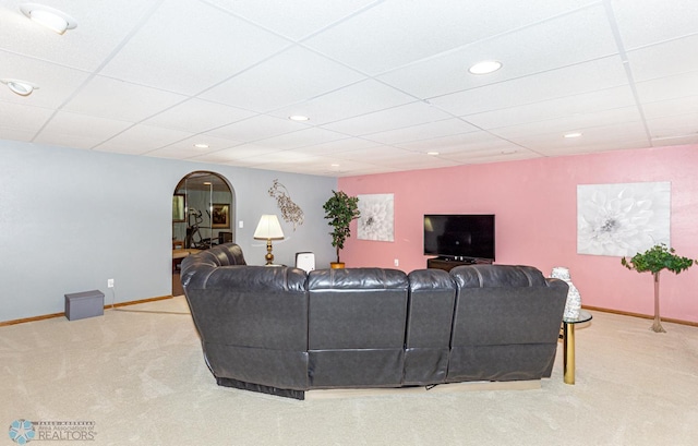 carpeted living room featuring a paneled ceiling