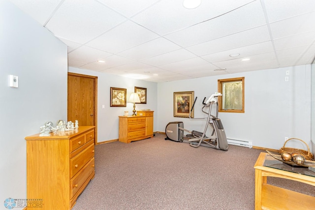 exercise room featuring light carpet and a paneled ceiling