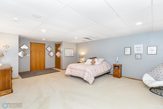 bedroom with carpet flooring and a paneled ceiling