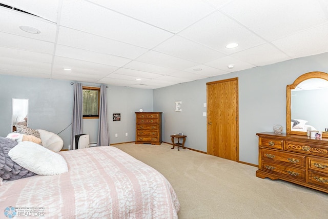 bedroom with carpet flooring and a drop ceiling