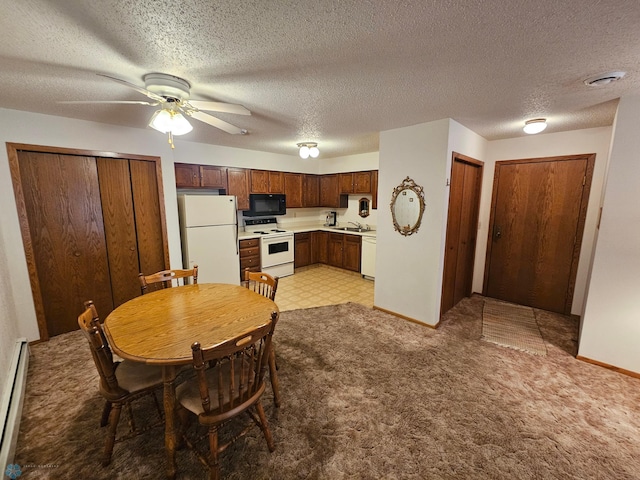 dining space featuring sink, ceiling fan, light colored carpet, a textured ceiling, and a baseboard heating unit