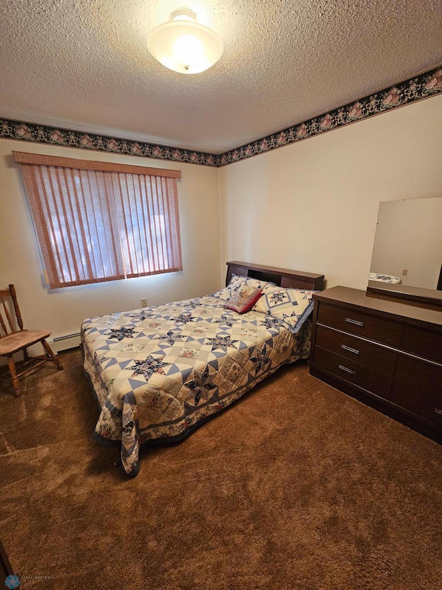 bedroom featuring a textured ceiling and dark carpet