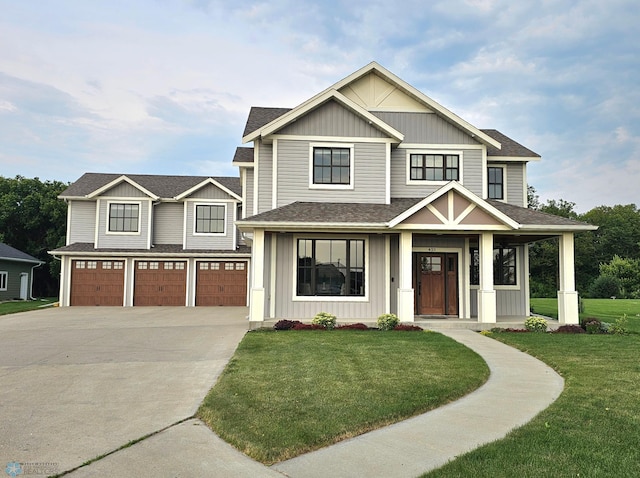 view of front of house with a front yard and a garage