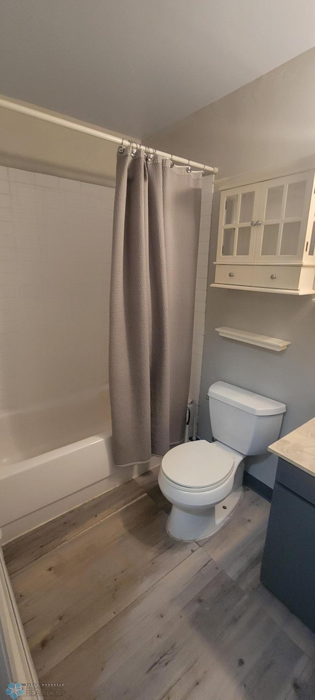 bathroom featuring vanity, toilet, and hardwood / wood-style floors