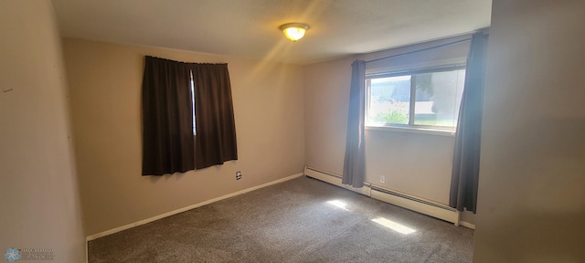 empty room featuring carpet and baseboard heating