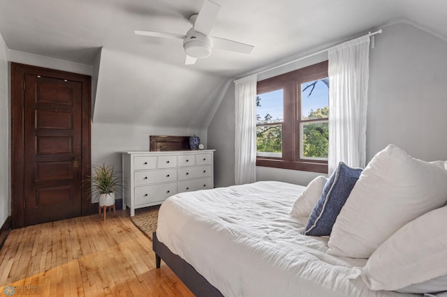 bedroom featuring lofted ceiling, light hardwood / wood-style floors, and ceiling fan