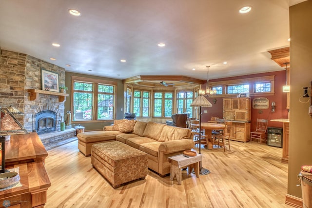 living room featuring a fireplace, light hardwood / wood-style flooring, and a wealth of natural light