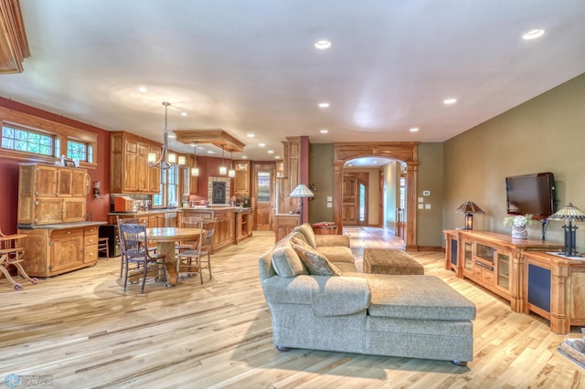 living room featuring a chandelier and light hardwood / wood-style flooring