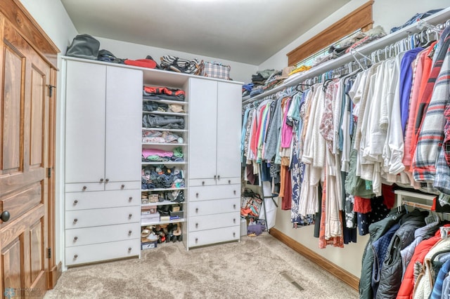 spacious closet with light colored carpet