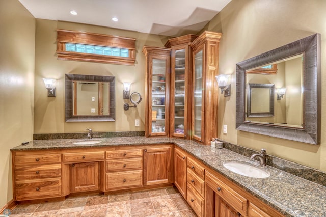 bathroom with tile patterned floors and dual bowl vanity