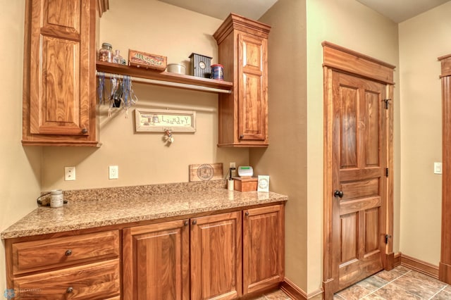 kitchen featuring light stone counters and light tile patterned floors