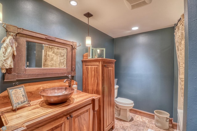 bathroom featuring tile patterned floors, vanity, and toilet