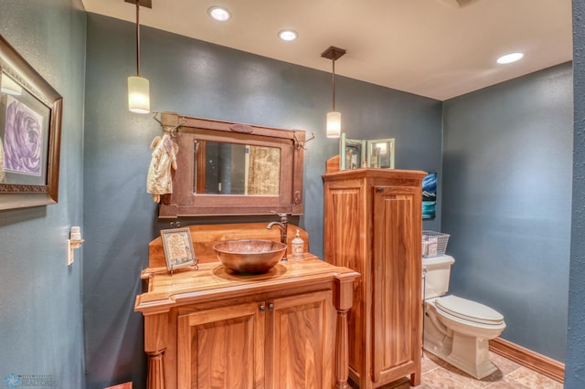 bathroom featuring tile patterned floors, toilet, and vanity