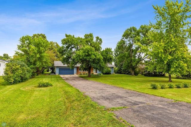 view of front of house featuring a garage and a front lawn