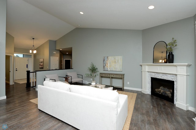 living room with dark hardwood / wood-style floors and lofted ceiling