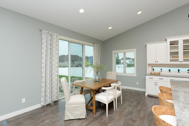 dining room featuring dark hardwood / wood-style floors and high vaulted ceiling