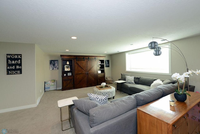 carpeted living room with a barn door