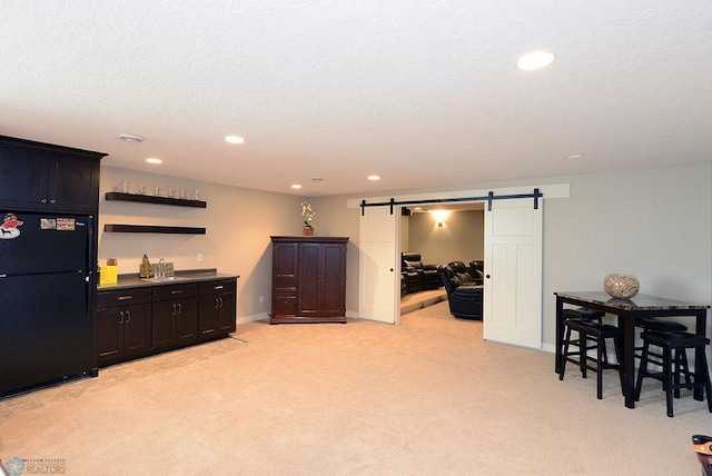 interior space with a barn door and a textured ceiling