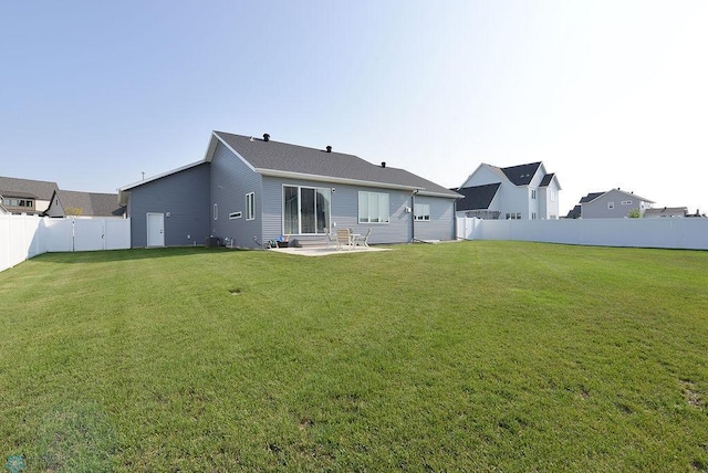 rear view of house with a yard and a patio area