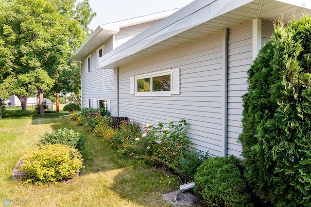 view of home's exterior with a yard