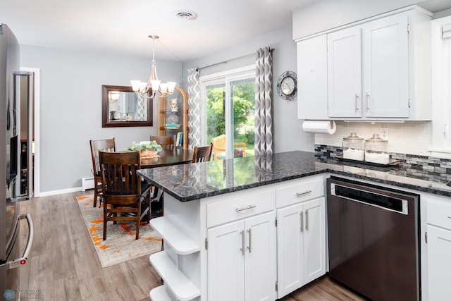 kitchen with dishwasher, dark stone counters, light hardwood / wood-style flooring, and kitchen peninsula