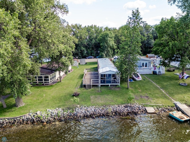 exterior space with a water view and a lawn