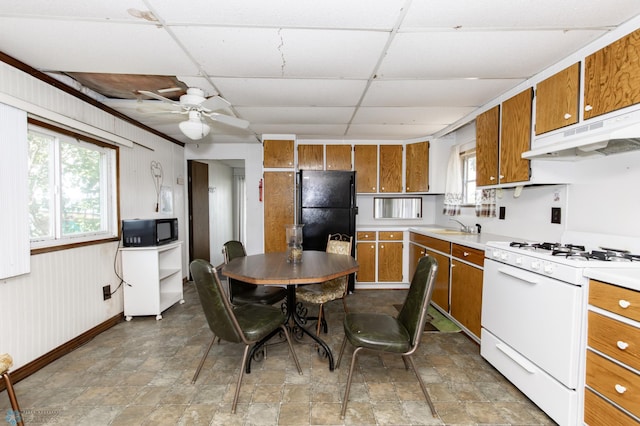 kitchen featuring ceiling fan, black appliances, a drop ceiling, and light tile patterned floors