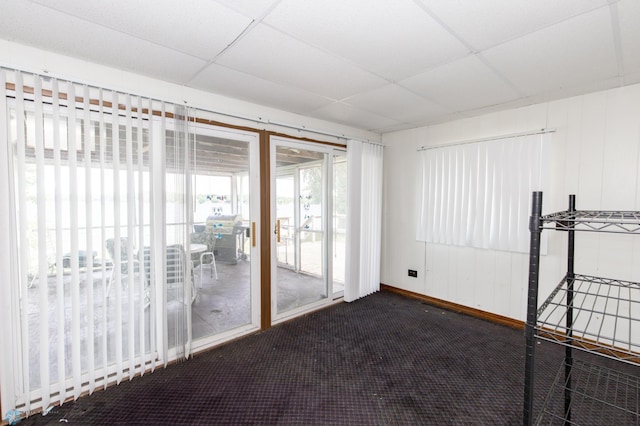 unfurnished room featuring a drop ceiling