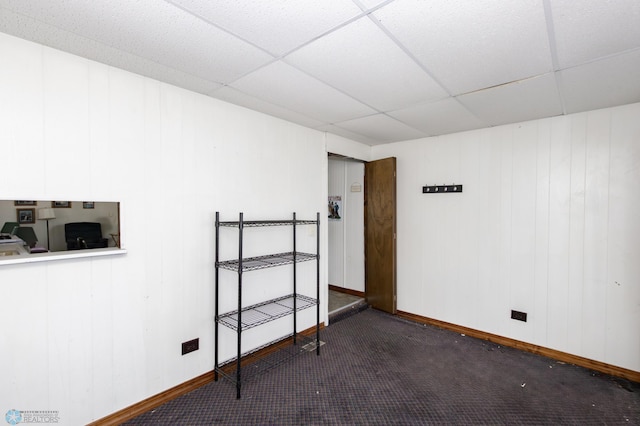 spare room with carpet flooring and a paneled ceiling