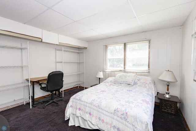 carpeted bedroom featuring a paneled ceiling