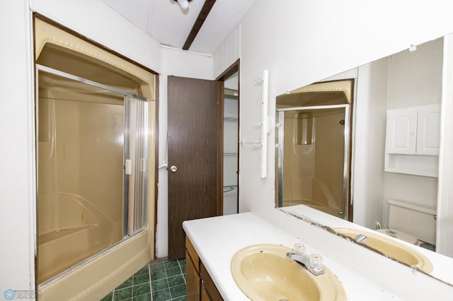 full bathroom with vanity, toilet, shower / bath combination with glass door, and tile patterned floors