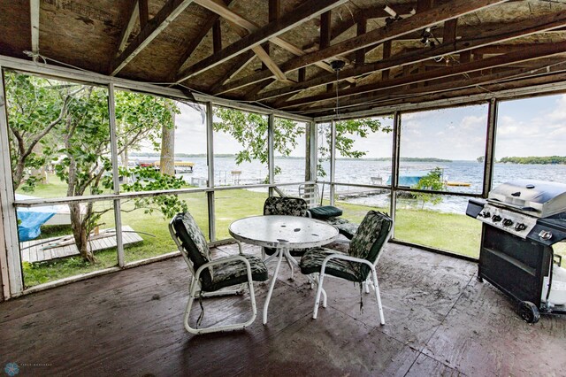 sunroom / solarium with a water view