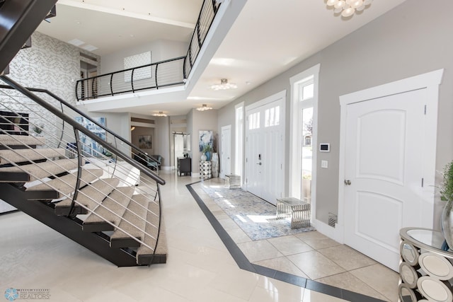 tiled entryway featuring a high ceiling