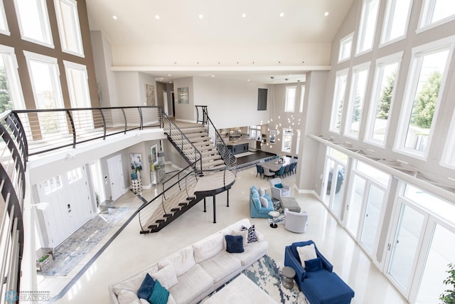 living room with a healthy amount of sunlight and a towering ceiling