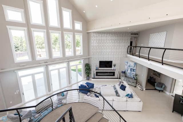 living room featuring high vaulted ceiling and plenty of natural light