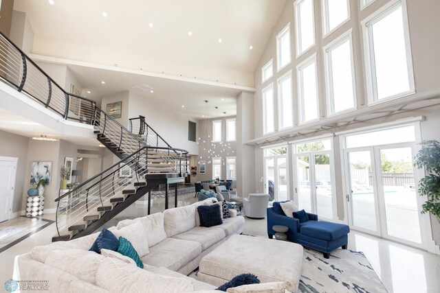 living room with a high ceiling and tile patterned floors