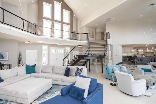 living room with tile patterned flooring and high vaulted ceiling