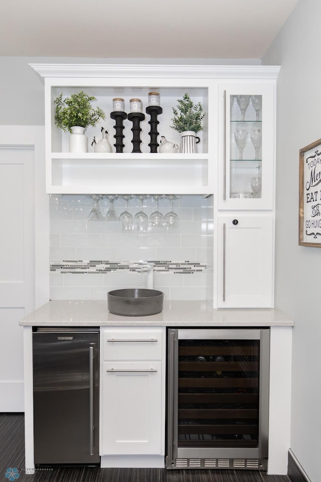 bar featuring white cabinetry, tasteful backsplash, wine cooler, and light stone counters