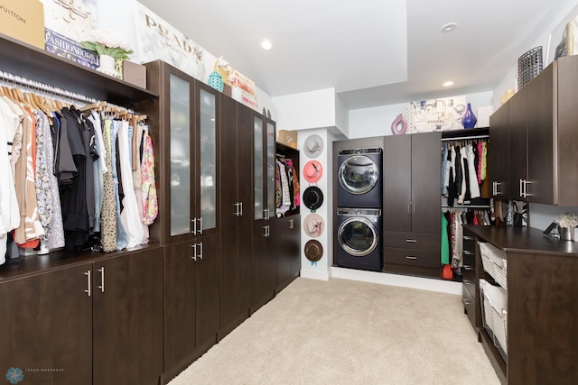 interior space with stacked washer / dryer and light colored carpet