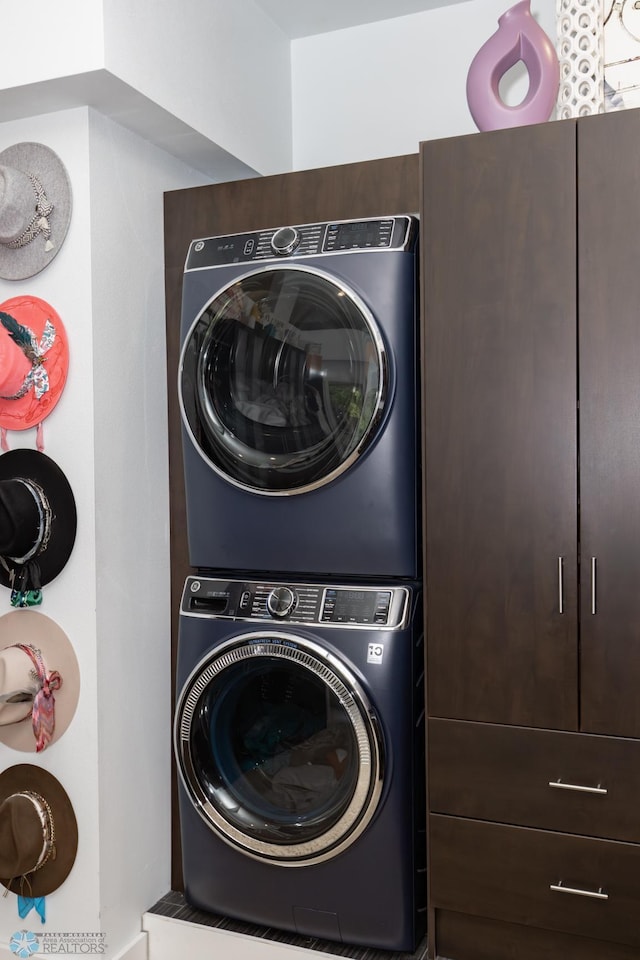 laundry area with stacked washer / drying machine