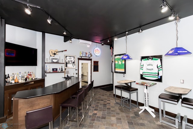 bar featuring a wall mounted AC, track lighting, decorative light fixtures, and dark tile patterned flooring