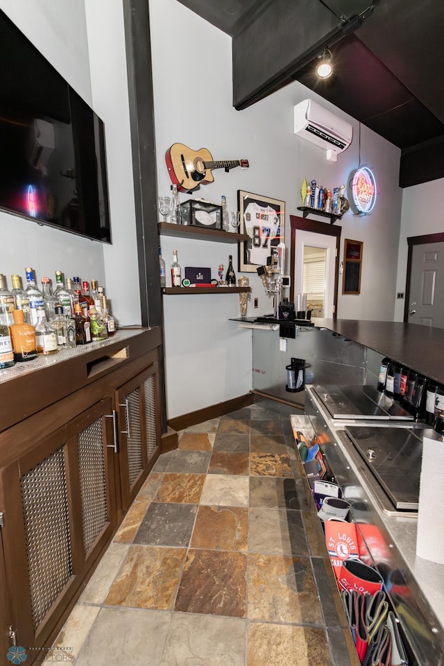 kitchen with a wall mounted air conditioner, track lighting, and tile patterned floors